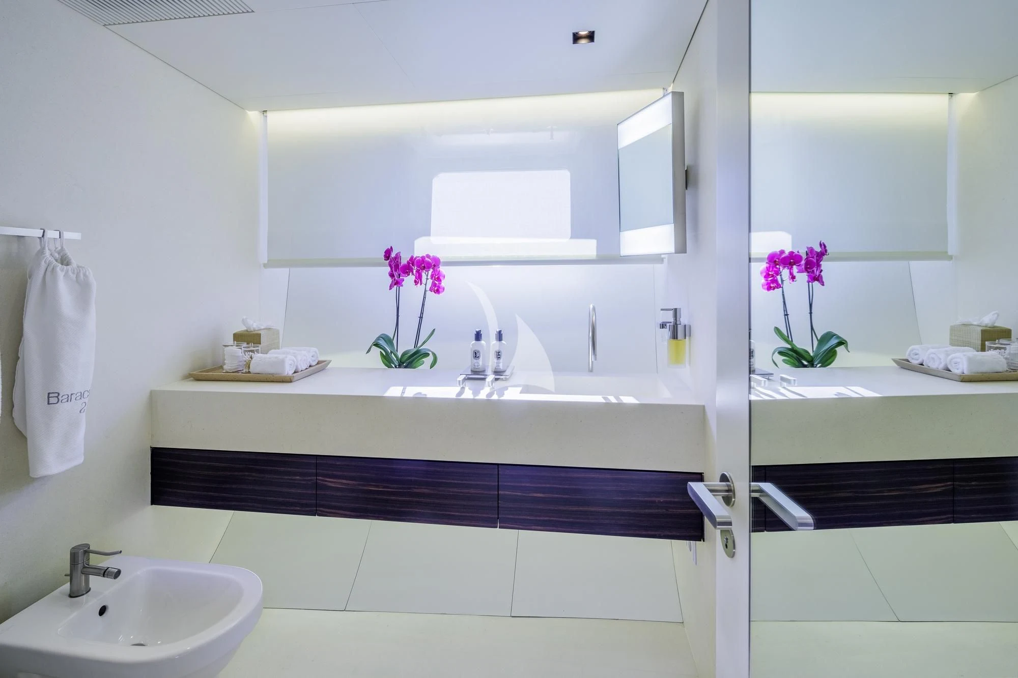 a bathroom with a sink and a mirror aboard BARACUDA VALLETTA Yacht for Sale