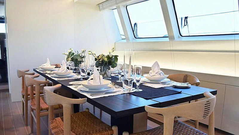 a table set with plates and glasses aboard BARACUDA VALLETTA Yacht for Sale