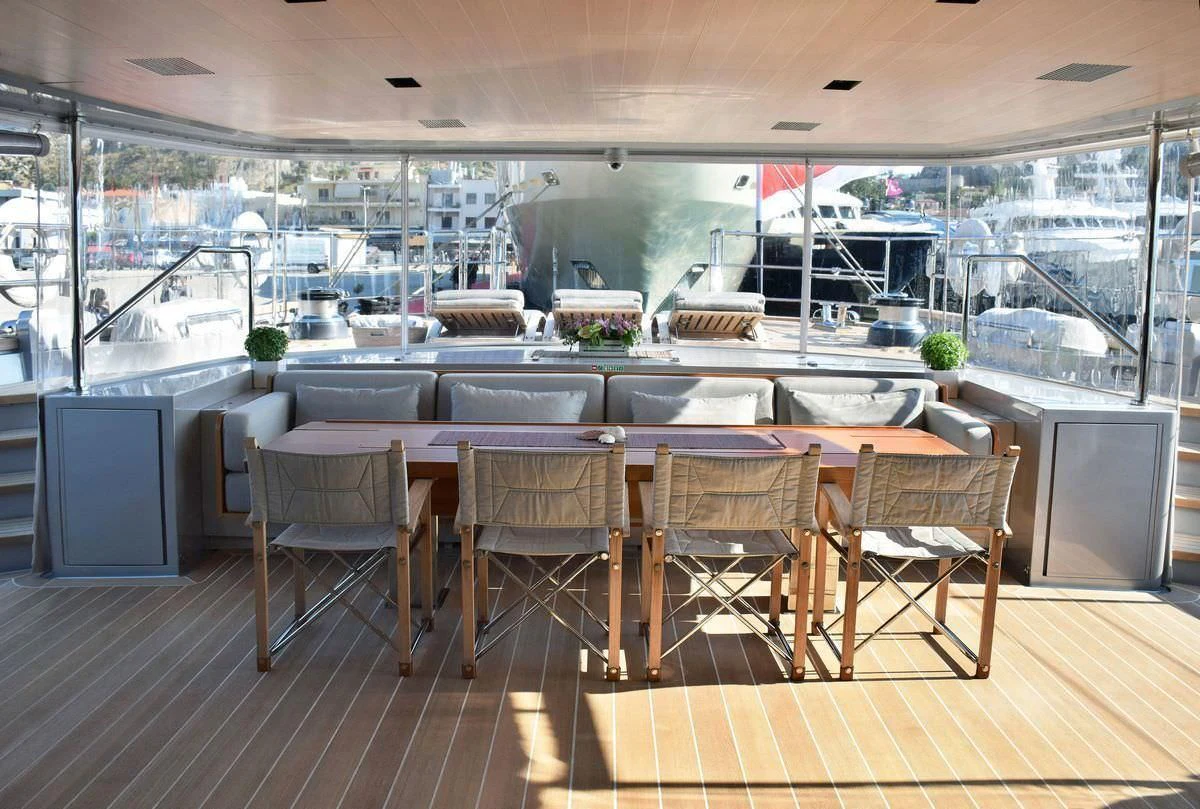 a room with a table chairs and a large window aboard BARACUDA VALLETTA Yacht for Sale