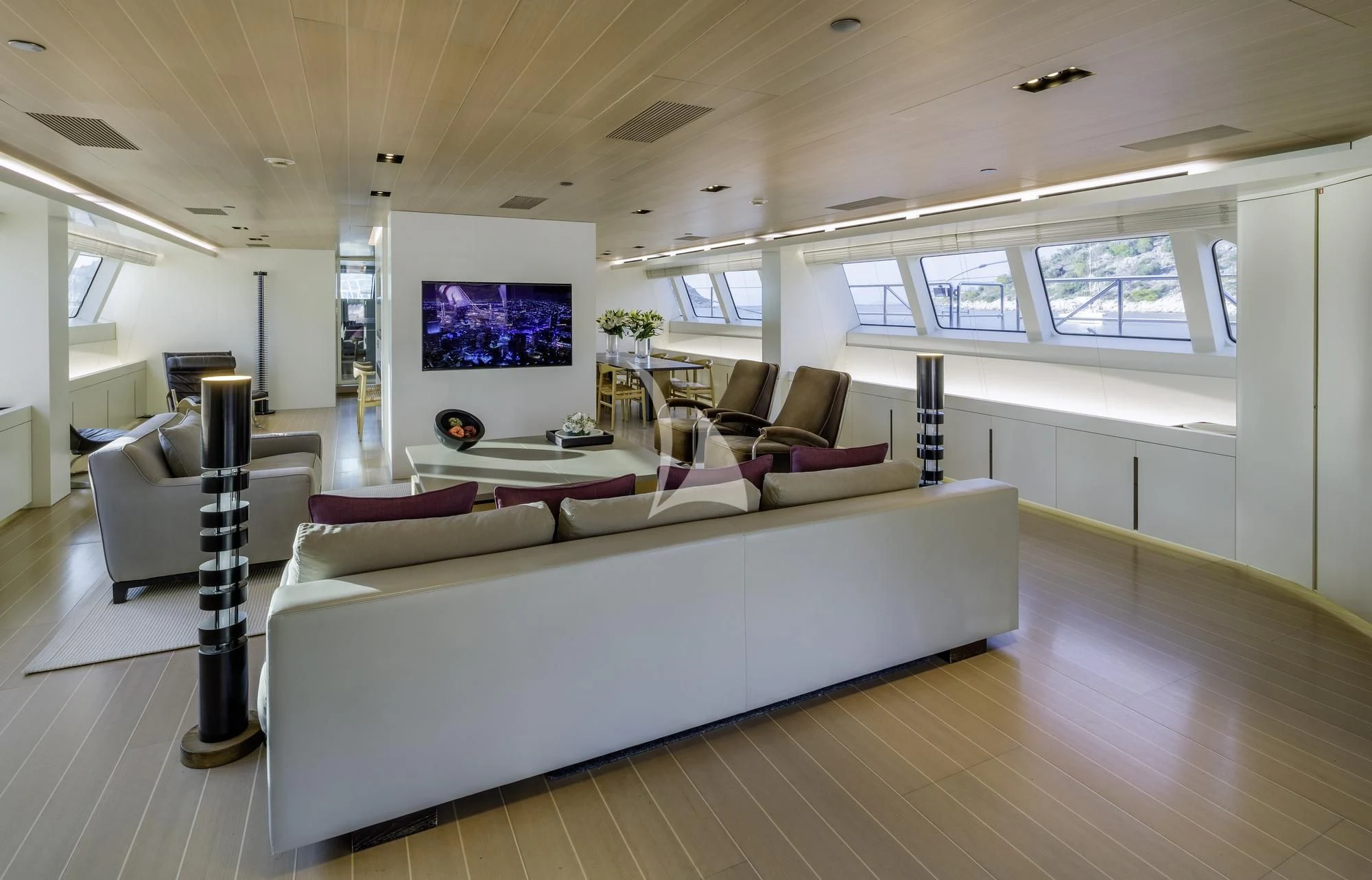 a living room with a large couch aboard BARACUDA VALLETTA Yacht for Sale