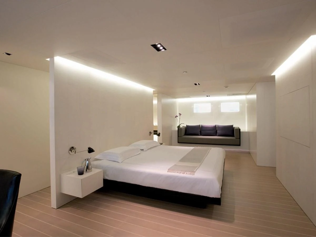 a bedroom with a bed and a couch aboard BARACUDA VALLETTA Yacht for Sale