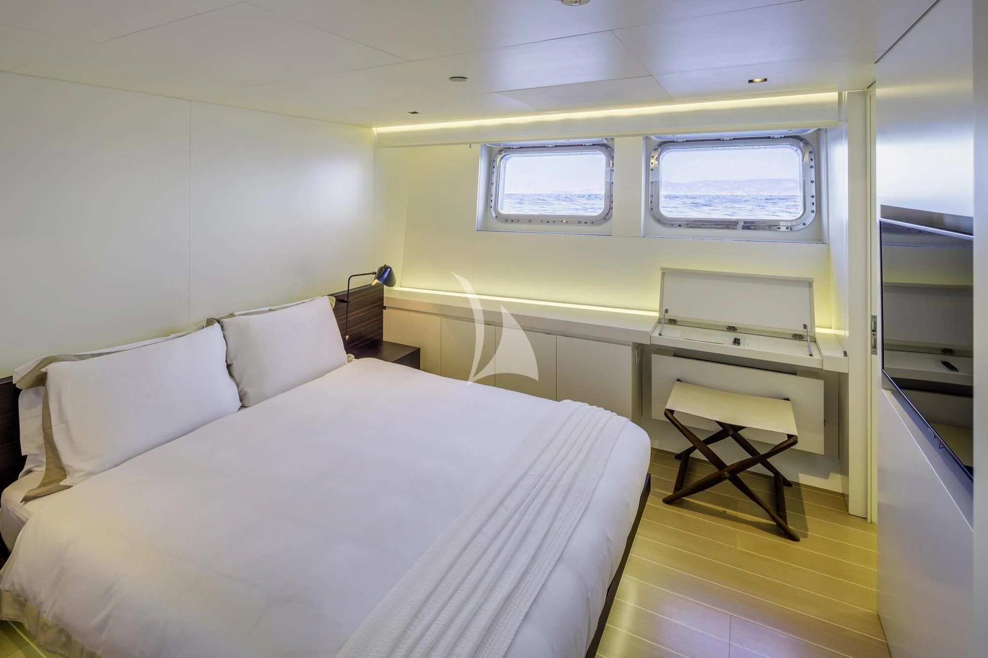 a room with a bed and a desk aboard BARACUDA VALLETTA Yacht for Sale