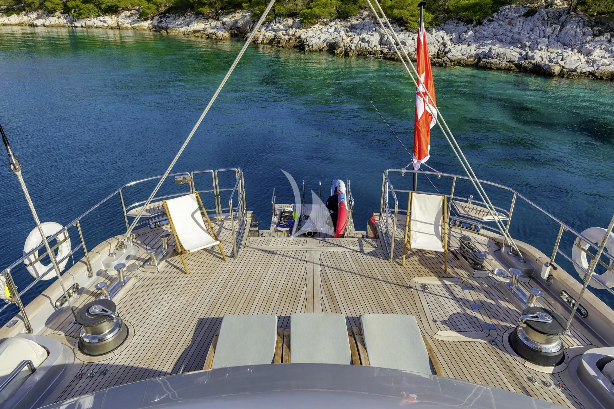 a deck with chairs and a boat on it aboard BARACUDA VALLETTA Yacht for Sale