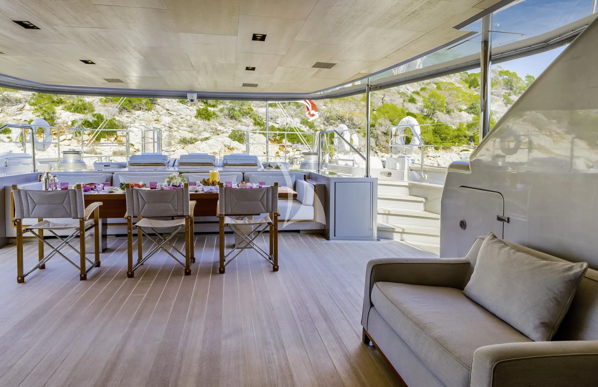 a large room with a table and chairs and a couch aboard BARACUDA VALLETTA Yacht for Sale