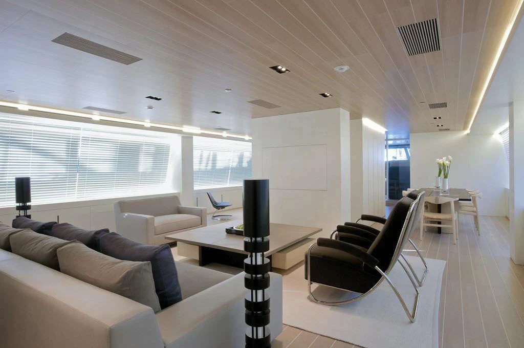 a living room with a tv and a table aboard BARACUDA VALLETTA Yacht for Sale