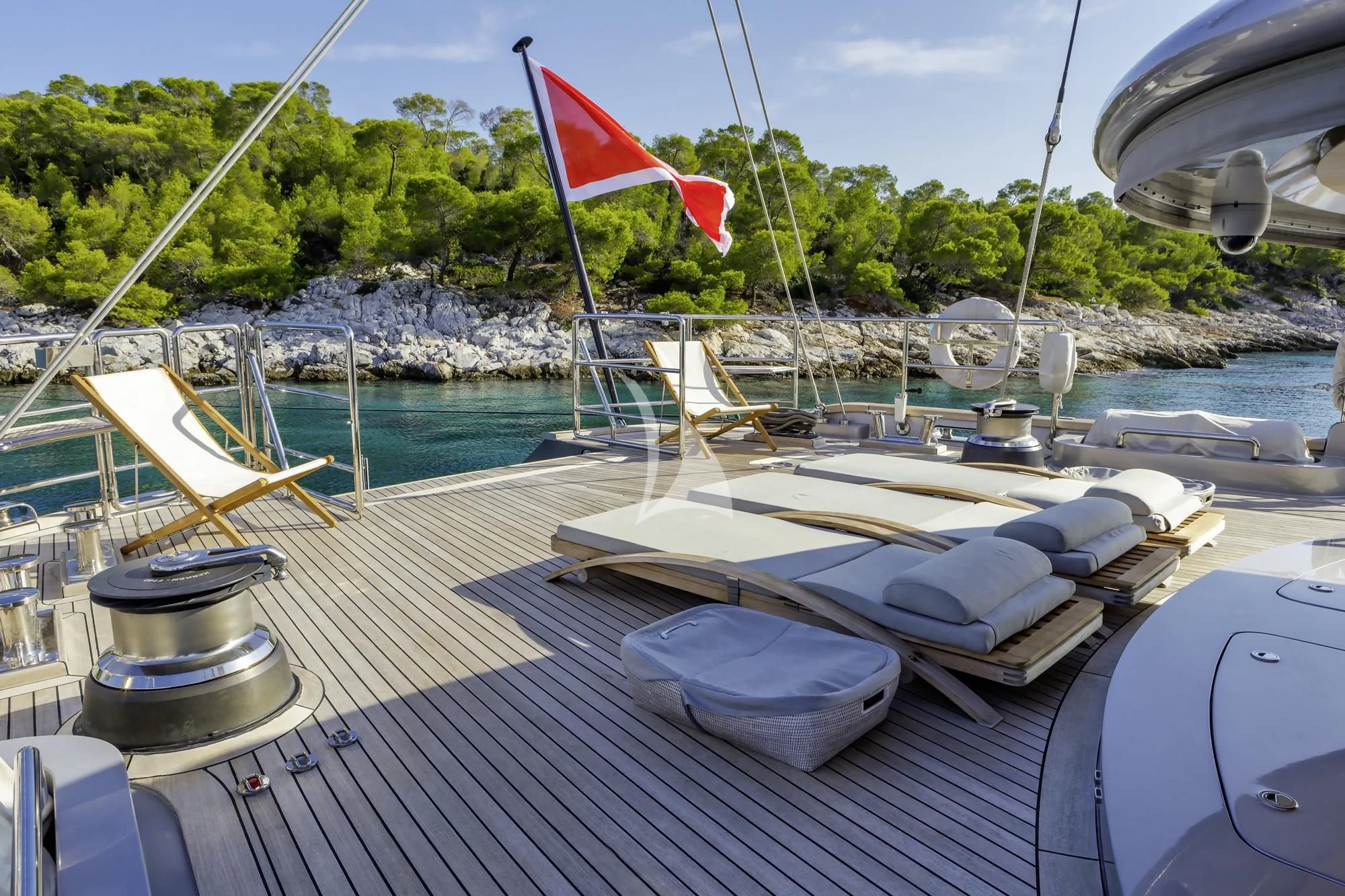 a boat on a deck with a flag on it aboard BARACUDA VALLETTA Yacht for Sale
