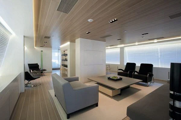 a living room with a couch and a table aboard BARACUDA VALLETTA Yacht for Sale