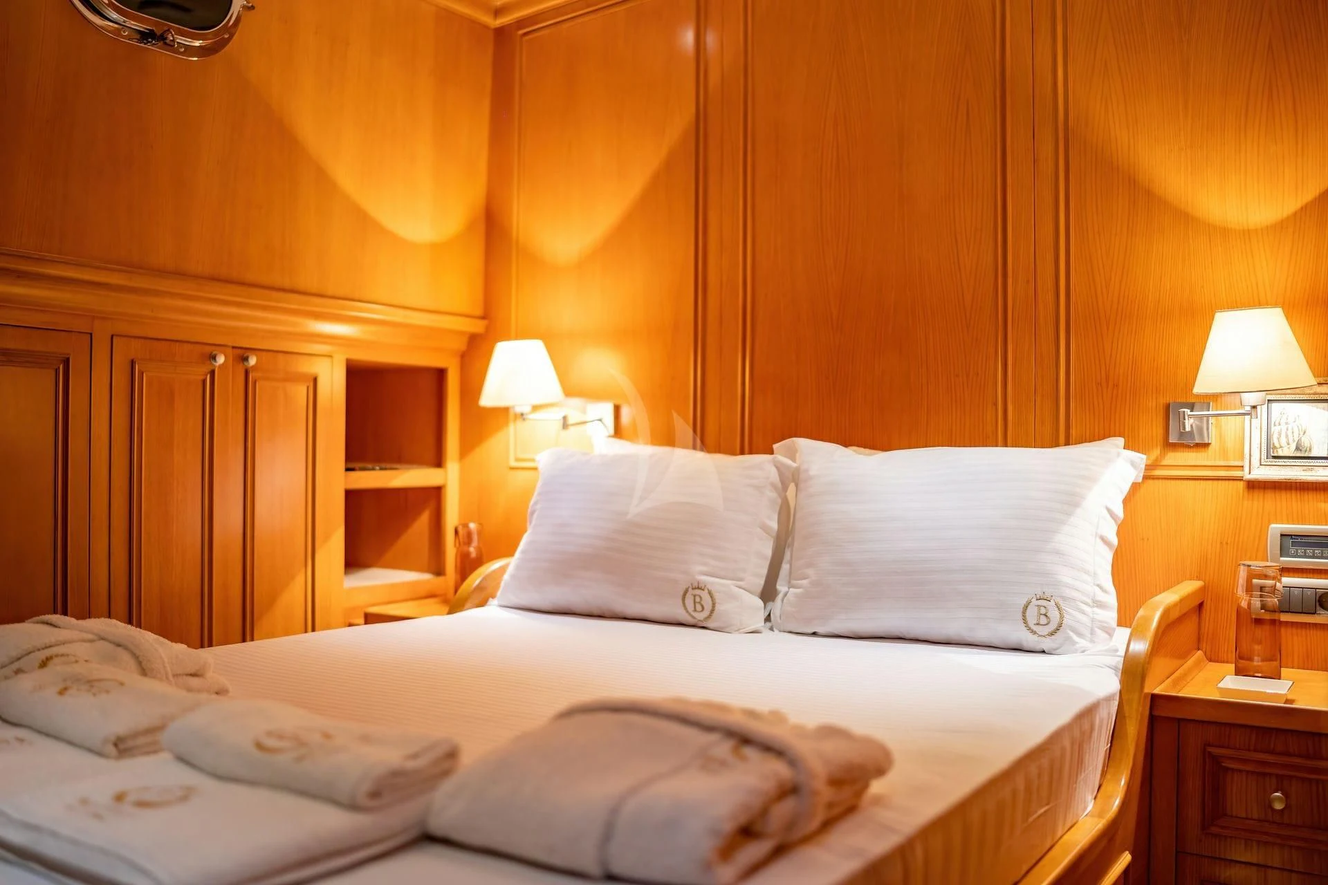 a bed with white sheets aboard BABYLON Yacht for Sale