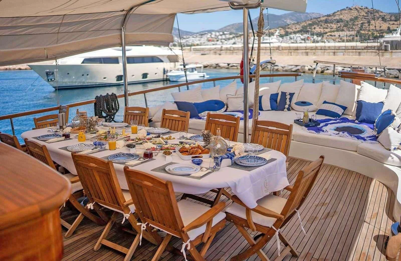 a table set for a meal on a boat aboard BABYLON Yacht for Sale