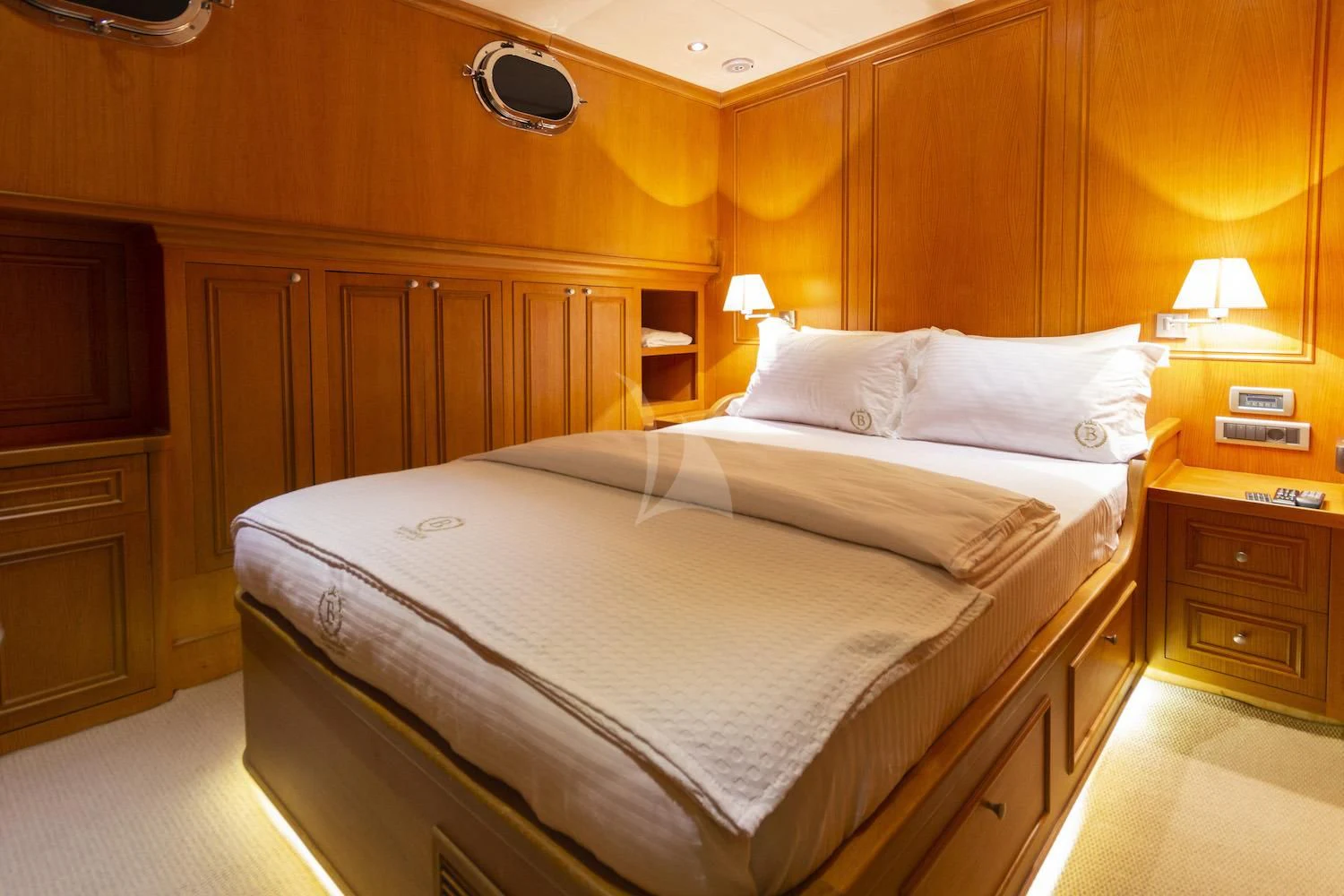 a bed with white sheets aboard BABYLON Yacht for Sale