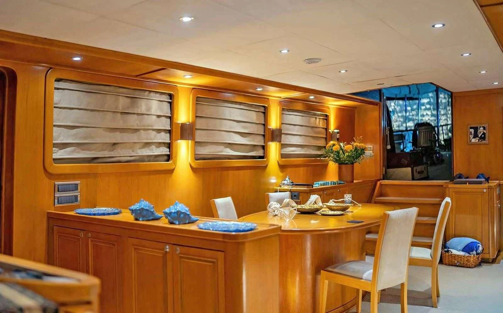 a kitchen with a table and chairs aboard BABYLON Yacht for Sale