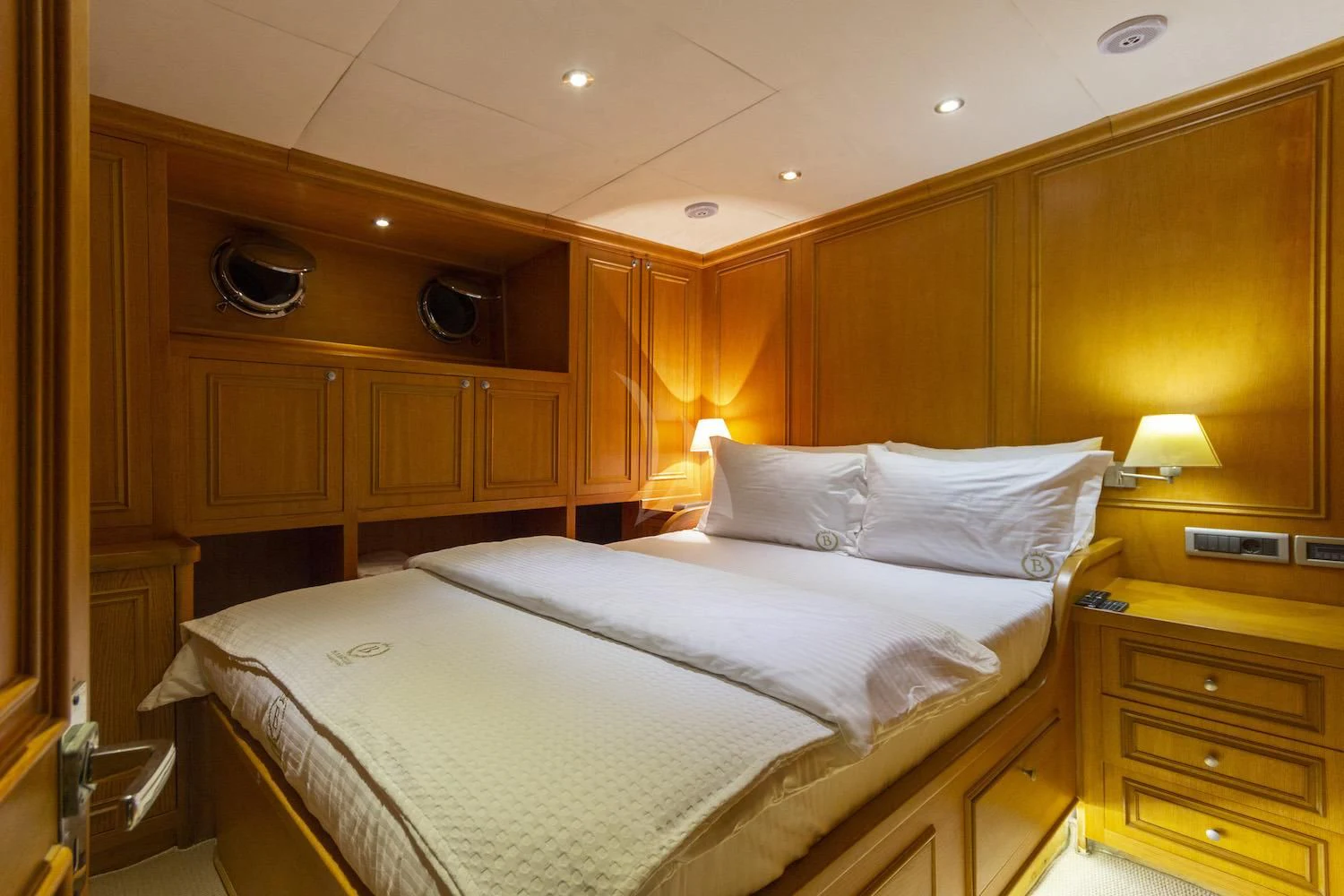 a bed with white sheets aboard BABYLON Yacht for Sale