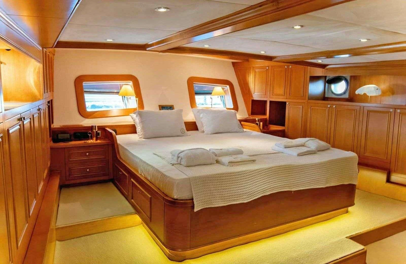 a room with a bed and a television aboard BABYLON Yacht for Sale