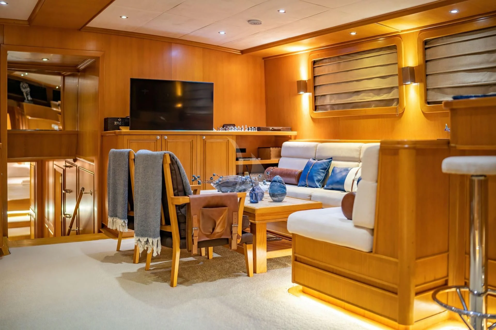 a living room with a couch and a table aboard BABYLON Yacht for Sale