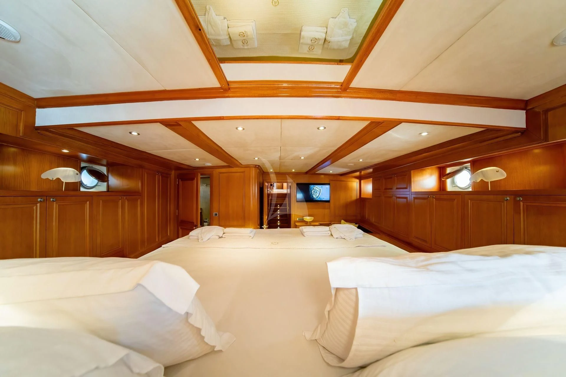 a room with a bed and a television aboard BABYLON Yacht for Sale