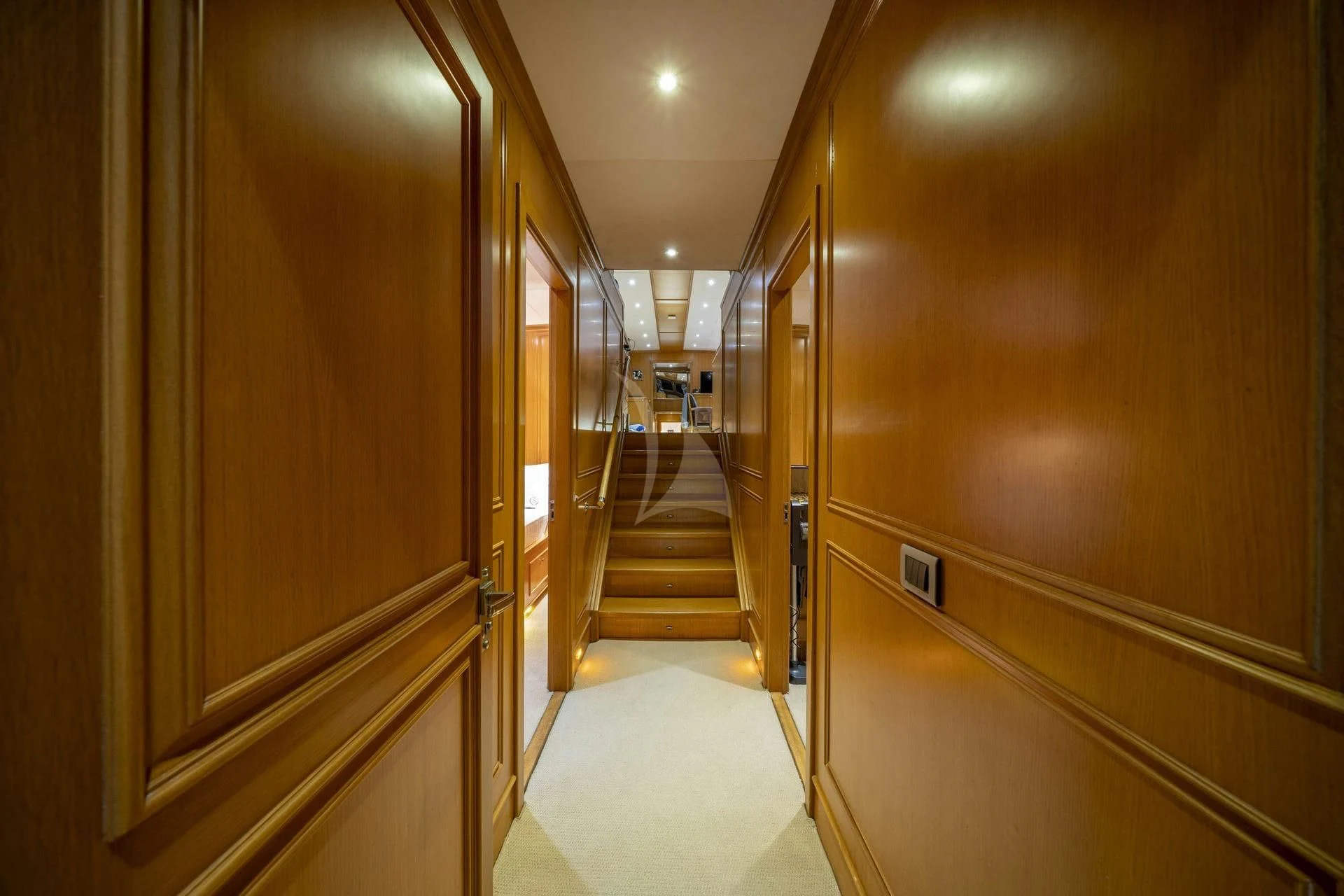 a hallway with a door and a carpet aboard BABYLON Yacht for Sale