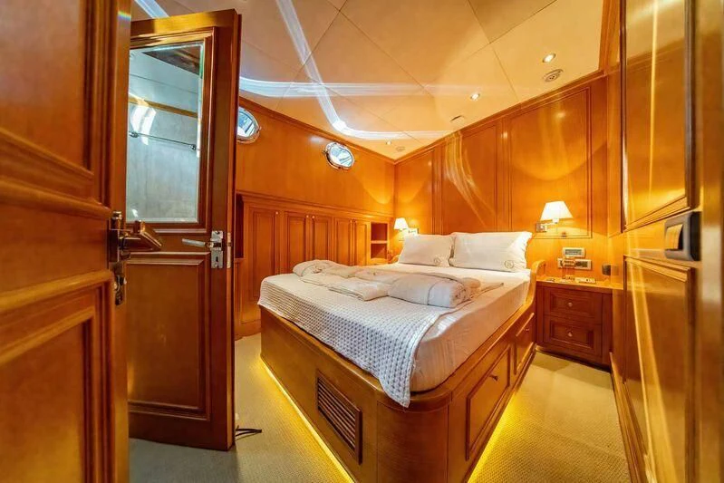 a bedroom with a bed and a closet aboard BABYLON Yacht for Sale