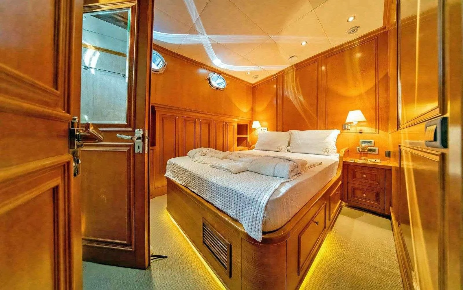 a room with a bed and a closet aboard BABYLON Yacht for Sale