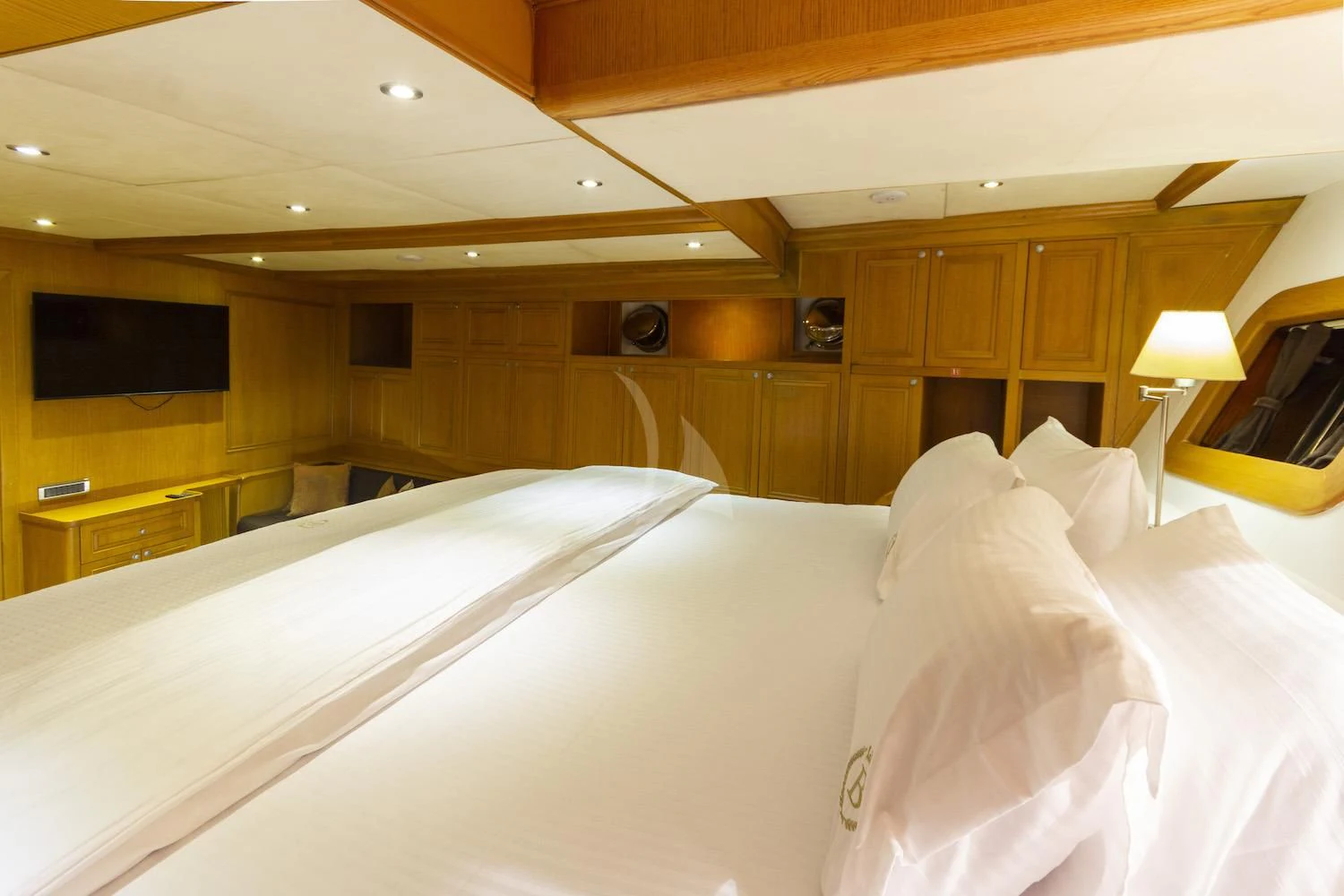 a room with a bed and a television aboard BABYLON Yacht for Sale