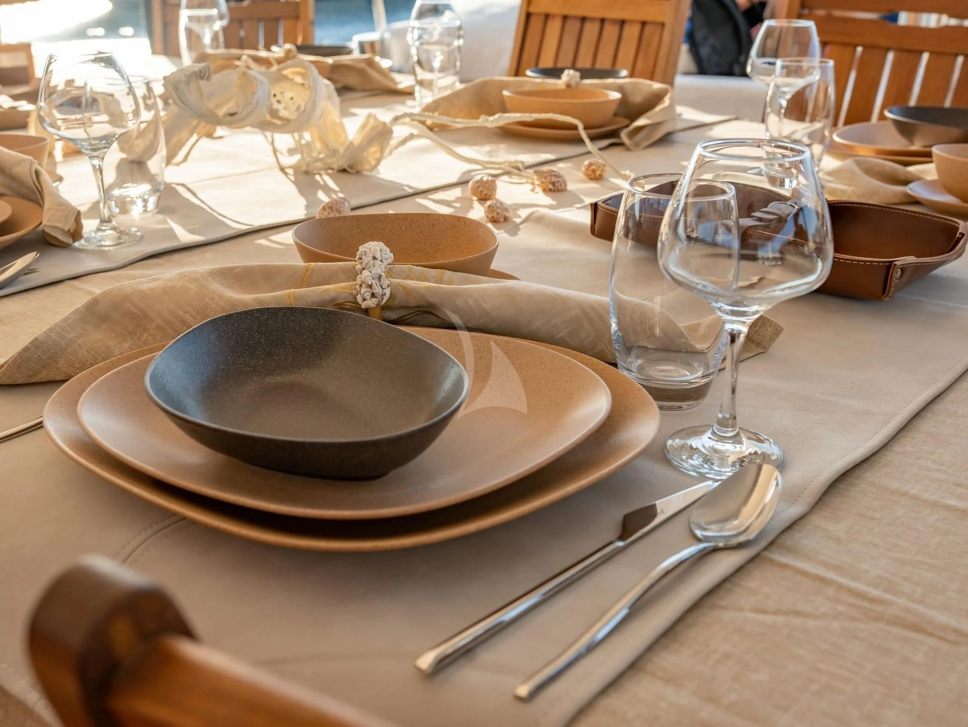 a table with plates and glasses aboard BABYLON Yacht for Sale