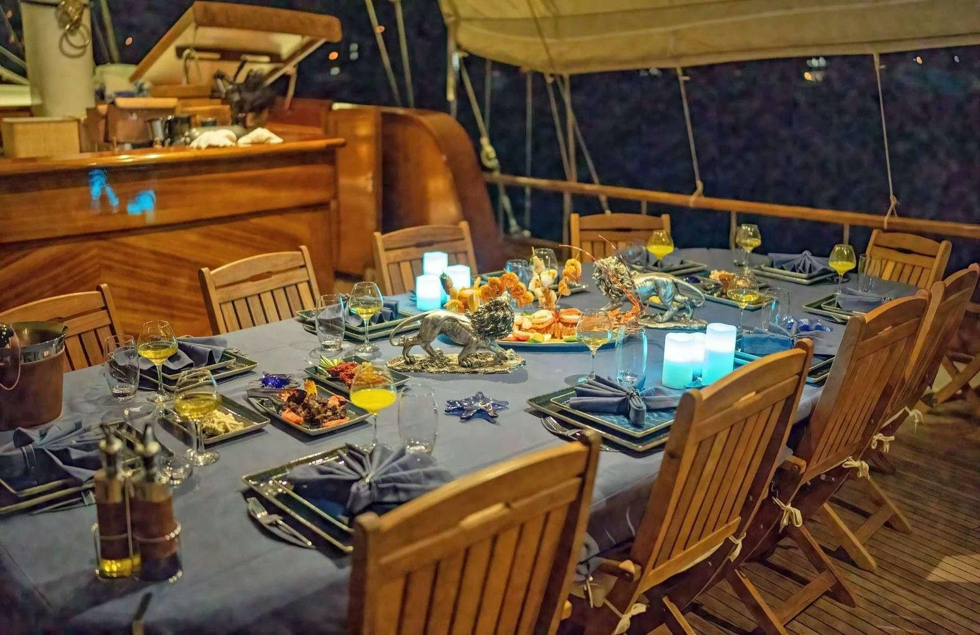 a table set with candles and a candle on it aboard BABYLON Yacht for Sale