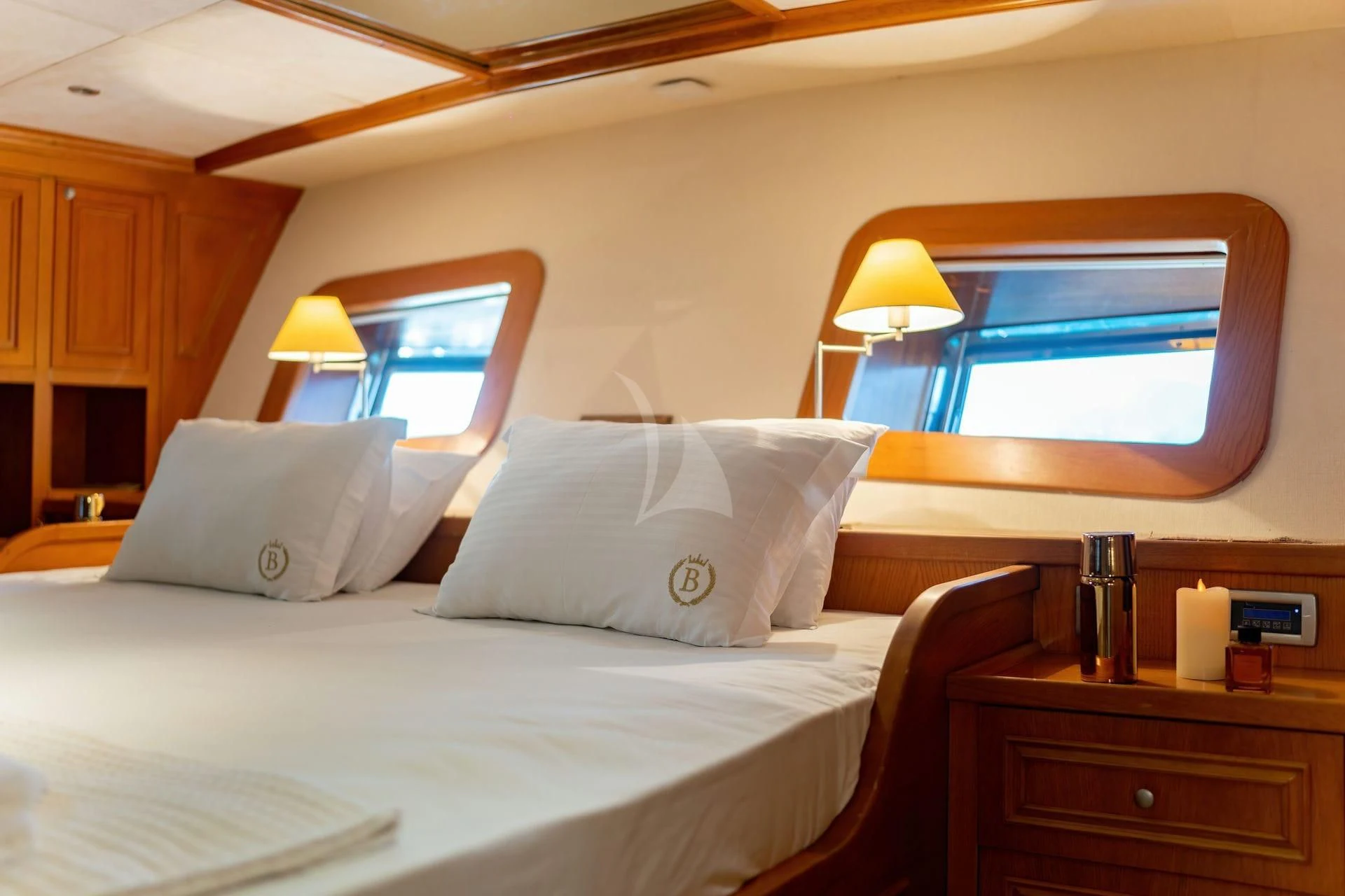 a bed with white sheets and pillows aboard BABYLON Yacht for Sale