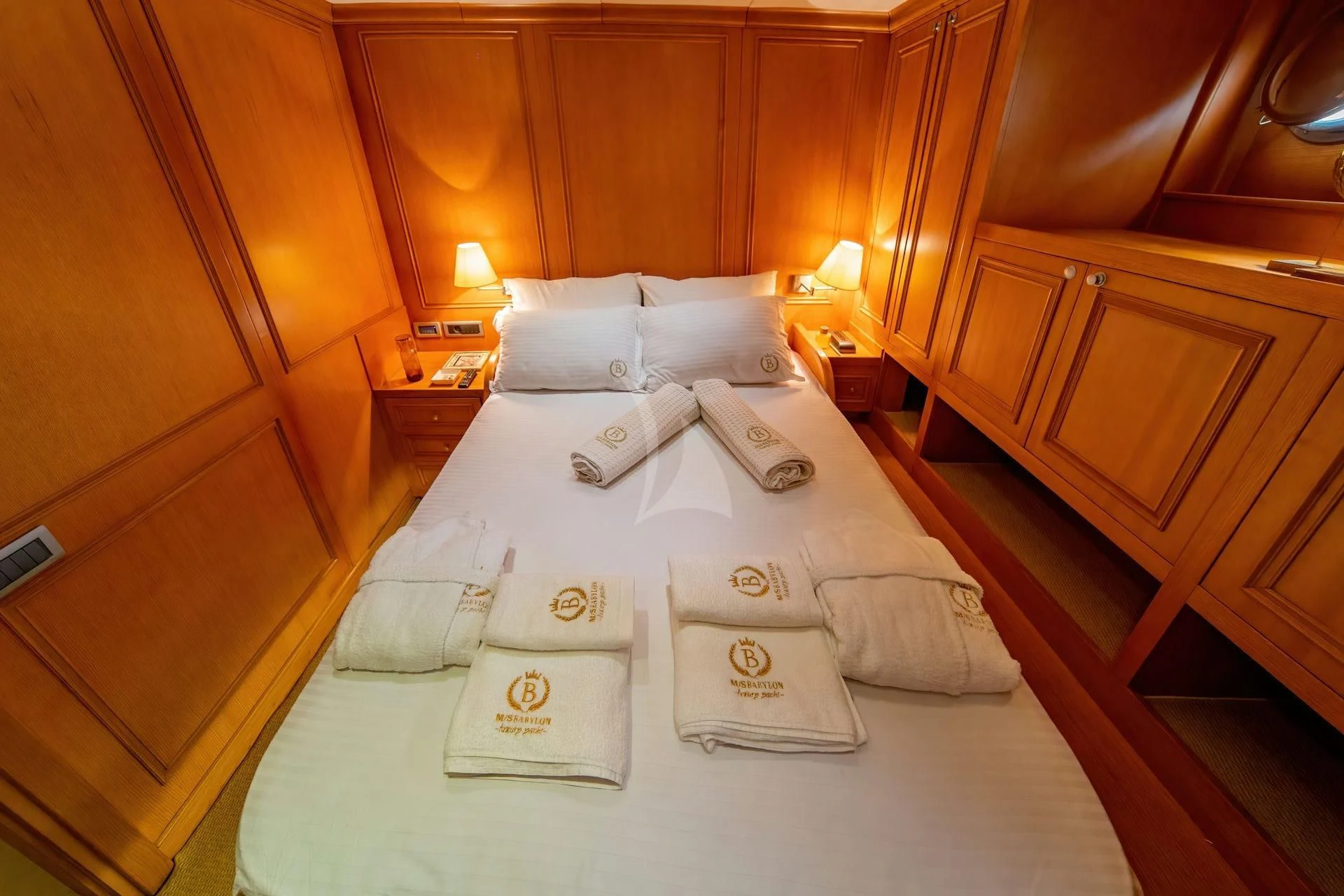 a bed with white sheets and pillows aboard BABYLON Yacht for Sale