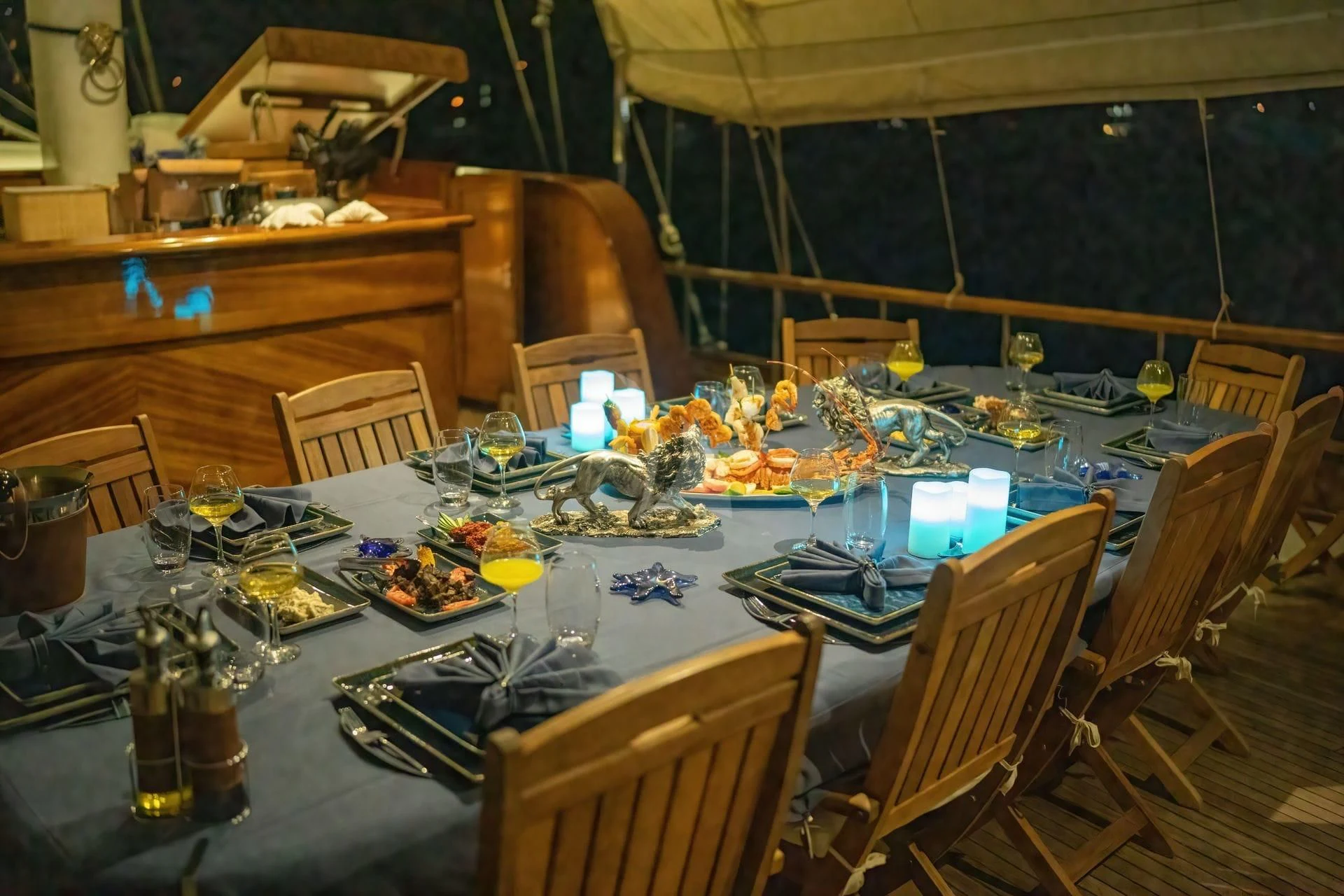 a table set with candles and a large window aboard BABYLON Yacht for Sale