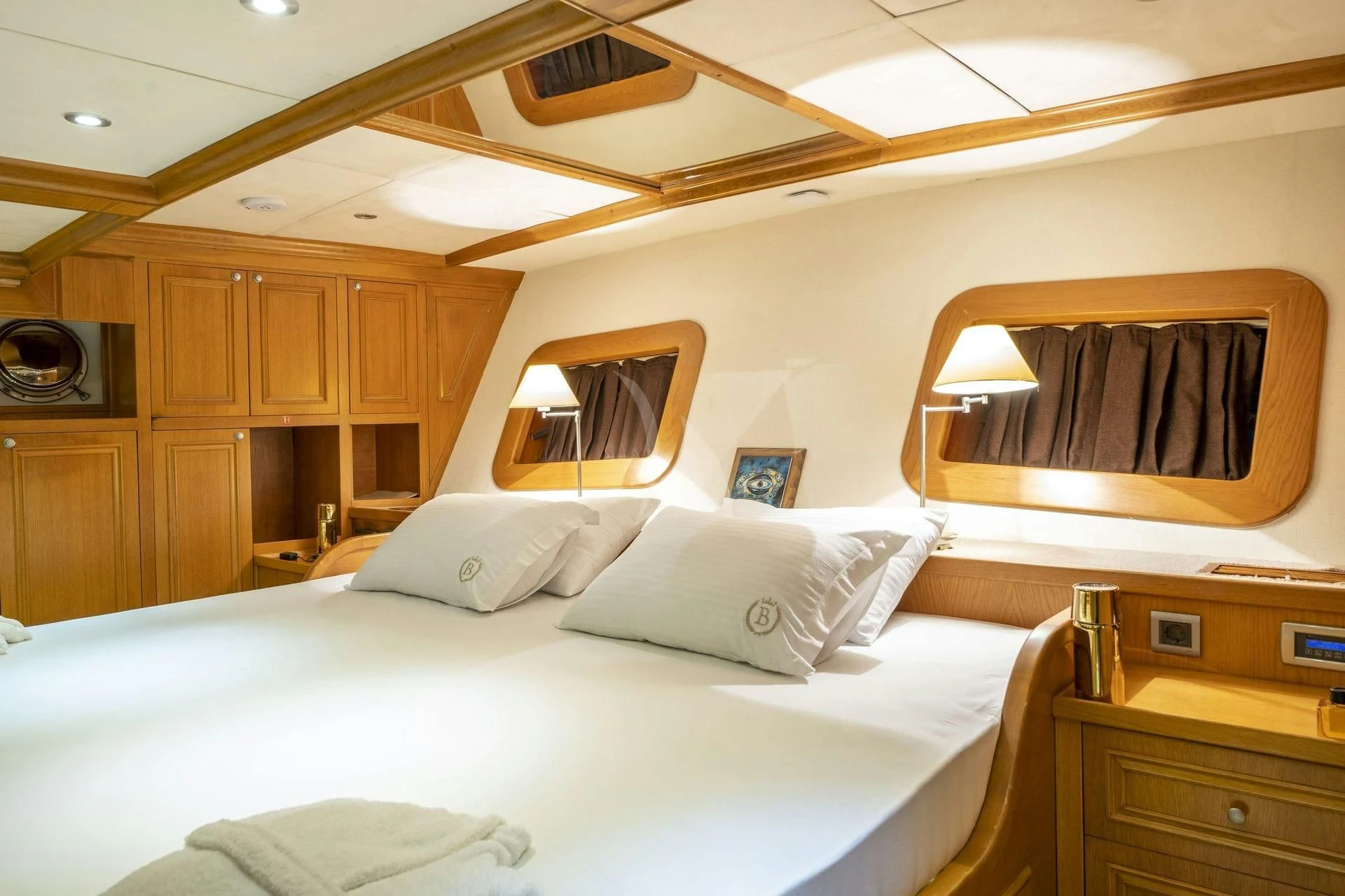 a hotel room with a bed and a television aboard BABYLON Yacht for Sale