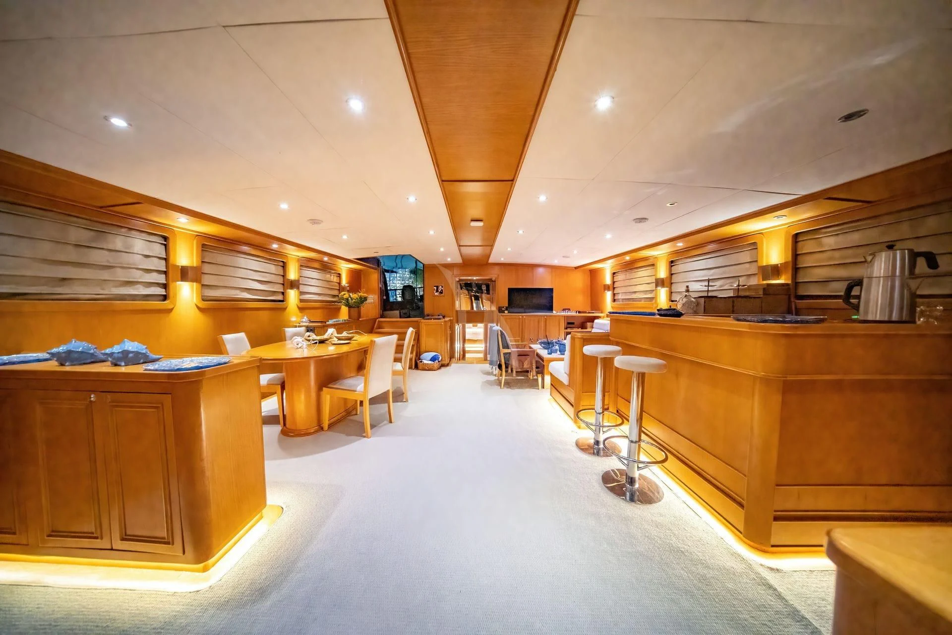 a large room with tables and chairs aboard BABYLON Yacht for Sale
