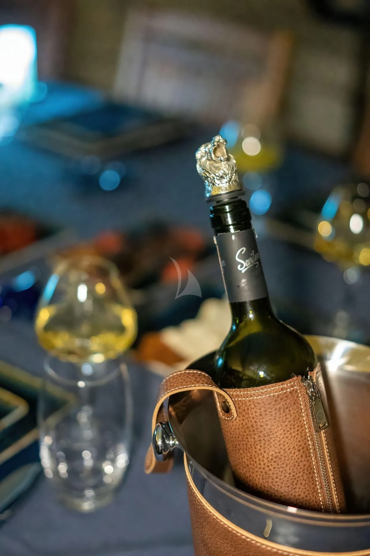 a bottle of liquor on a table aboard BABYLON Yacht for Sale