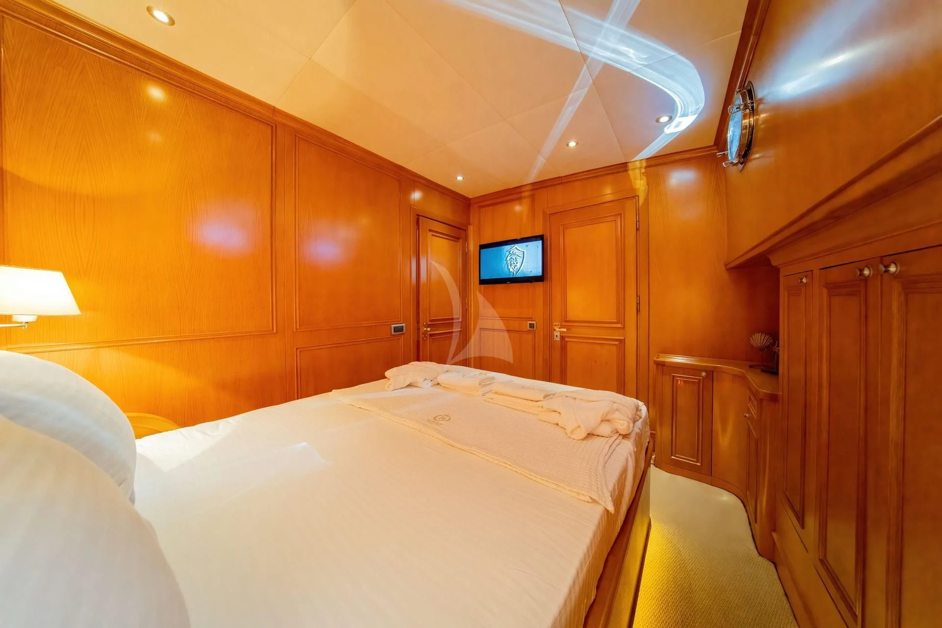 a room with a bed and a television aboard BABYLON Yacht for Sale