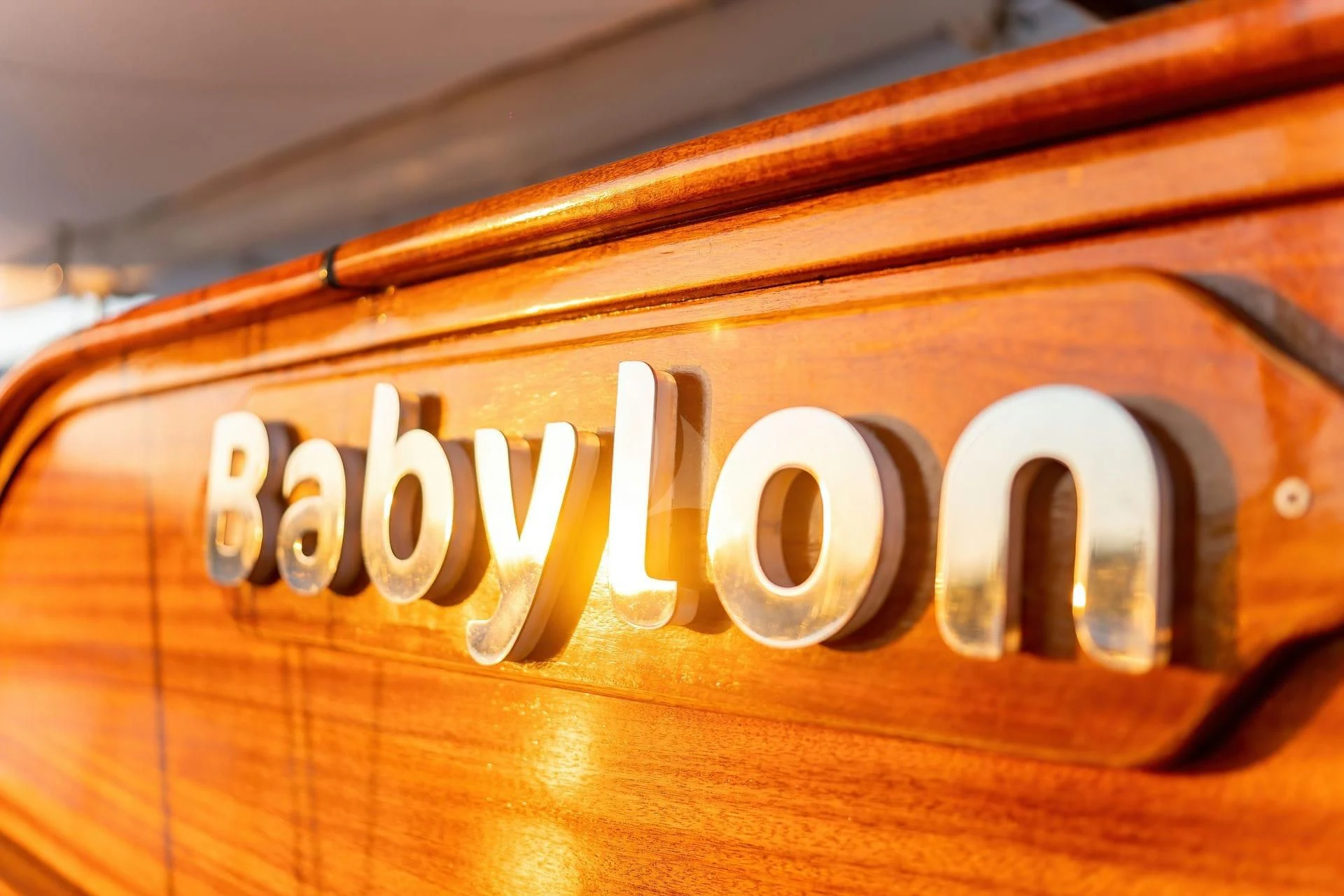 a wood sign with white letters aboard BABYLON Yacht for Sale