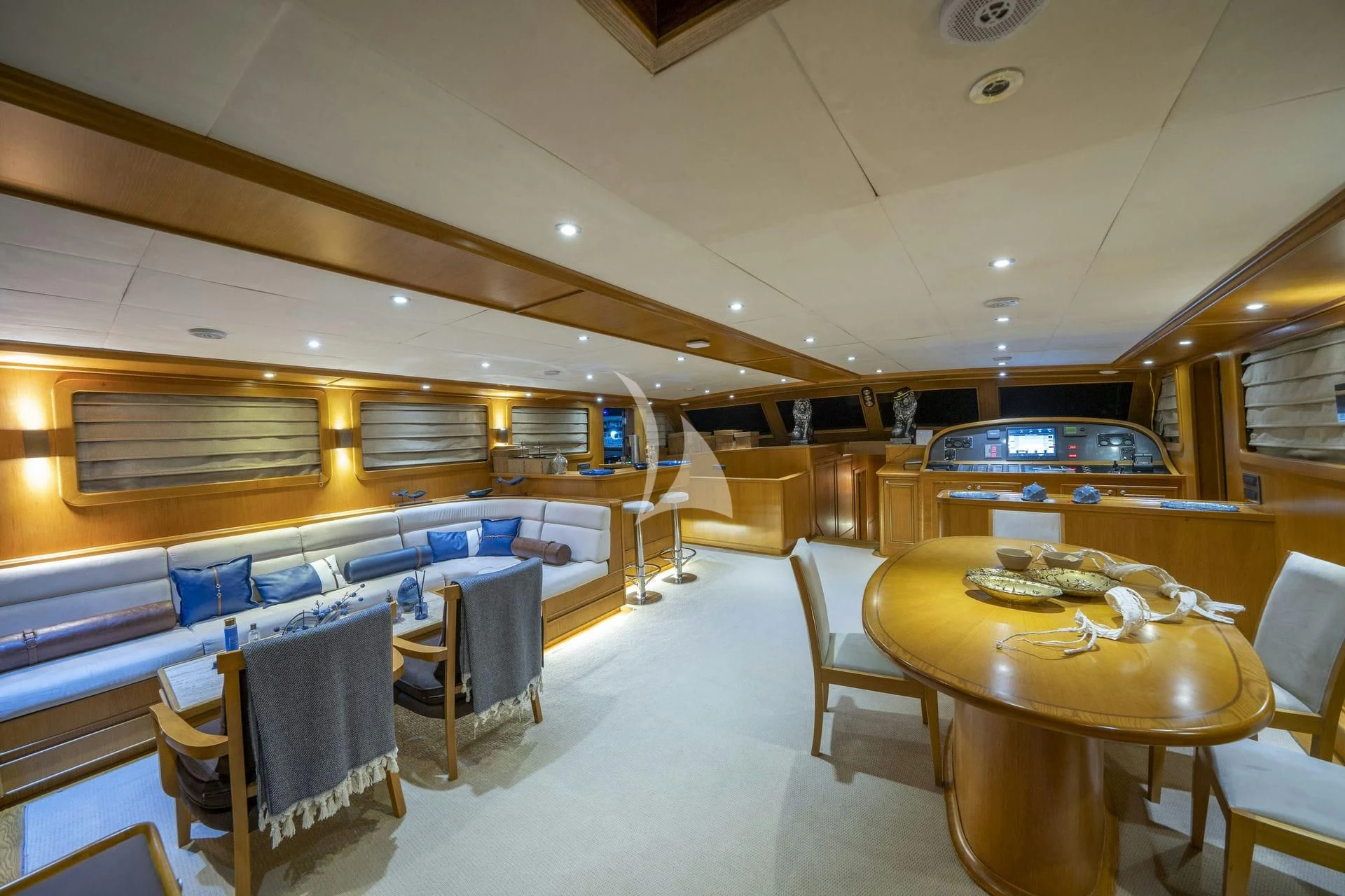 a room with a table chairs and a bed aboard BABYLON Yacht for Sale
