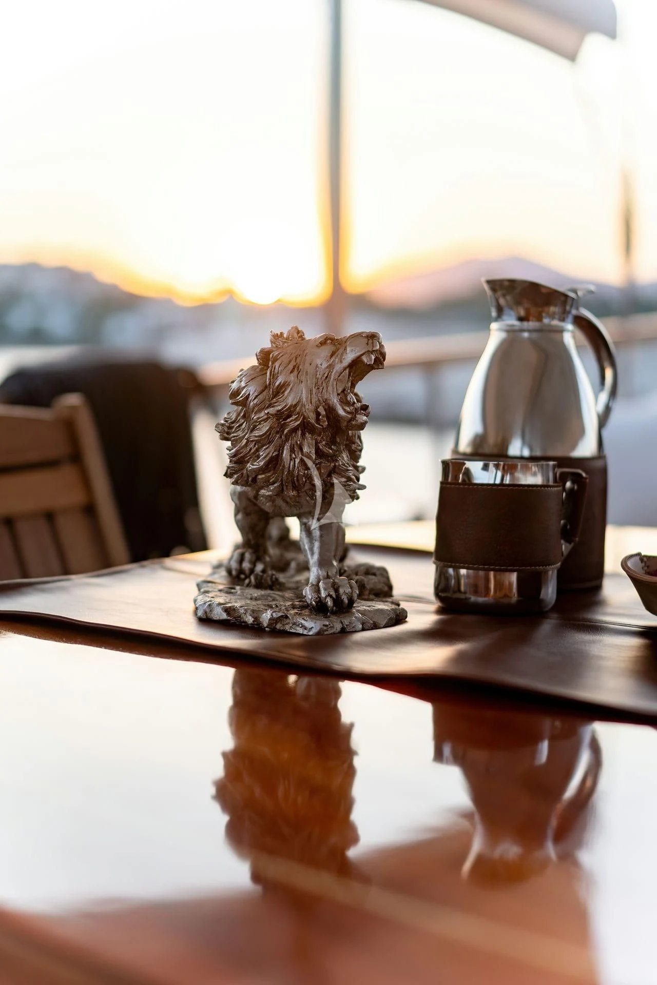 a glass of beer on a table aboard BABYLON Yacht for Sale