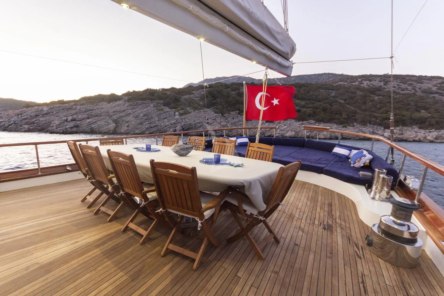 a table set on a deck overlooking a large body of water aboard BABYLON Yacht for Sale