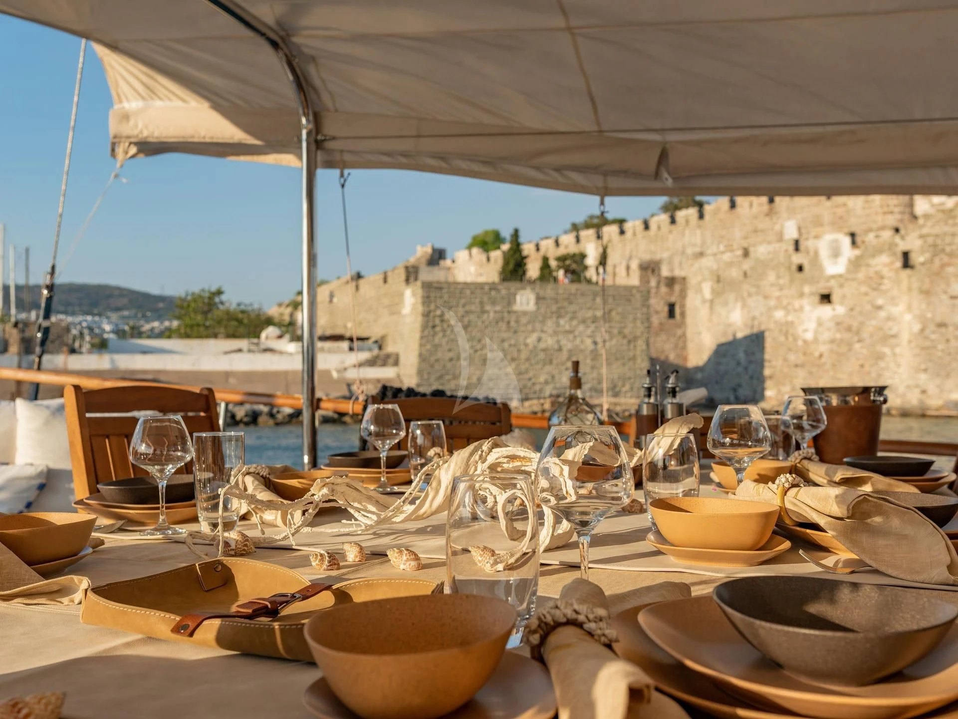 a table with food and glasses aboard BABYLON Yacht for Sale