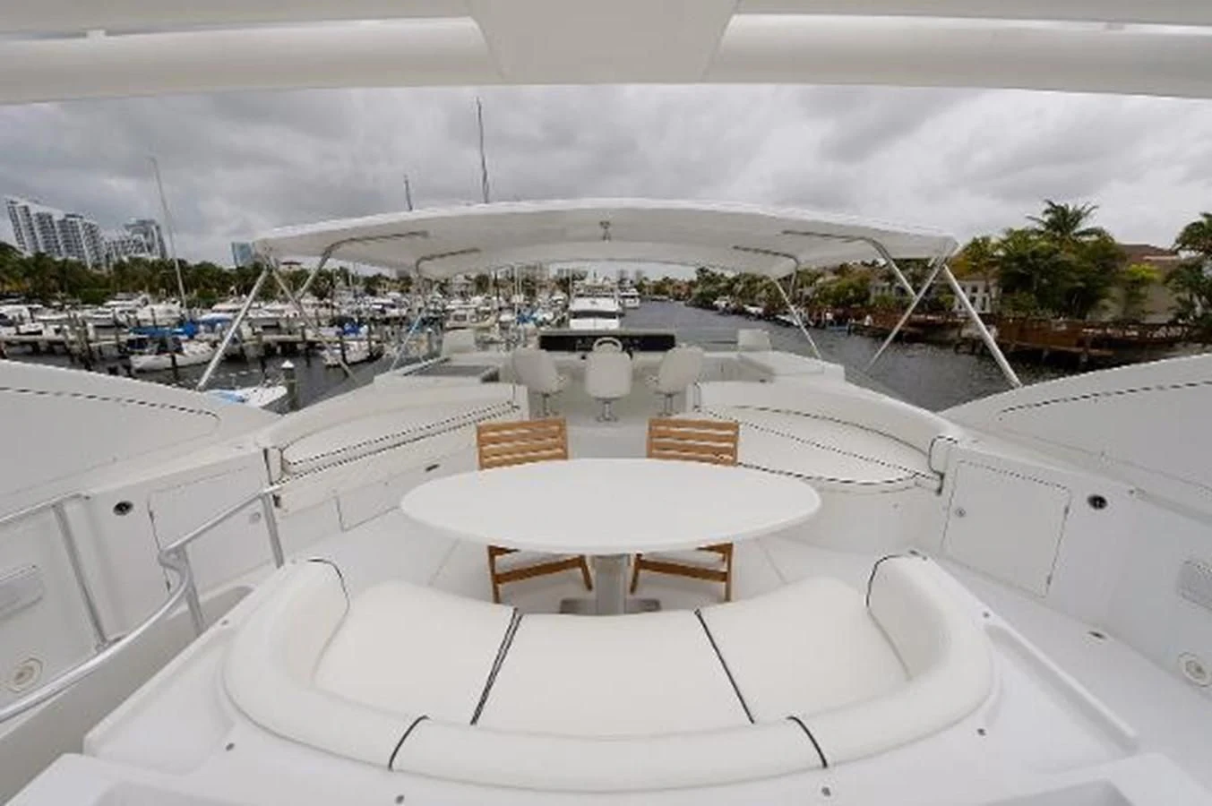 a large white building with a table and chairs on the deck aboard UTOPIA Yacht for Sale