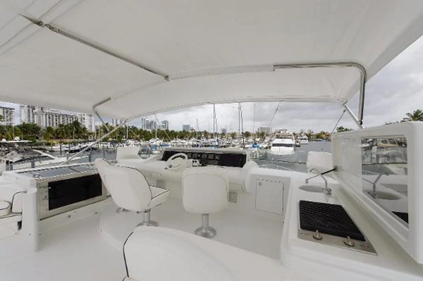 a room with a large white table and chairs and a laptop aboard UTOPIA Yacht for Sale