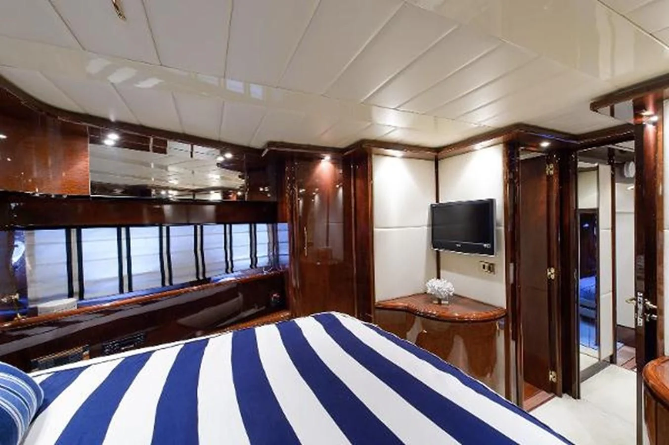 a room with a table and tv aboard UTOPIA Yacht for Sale