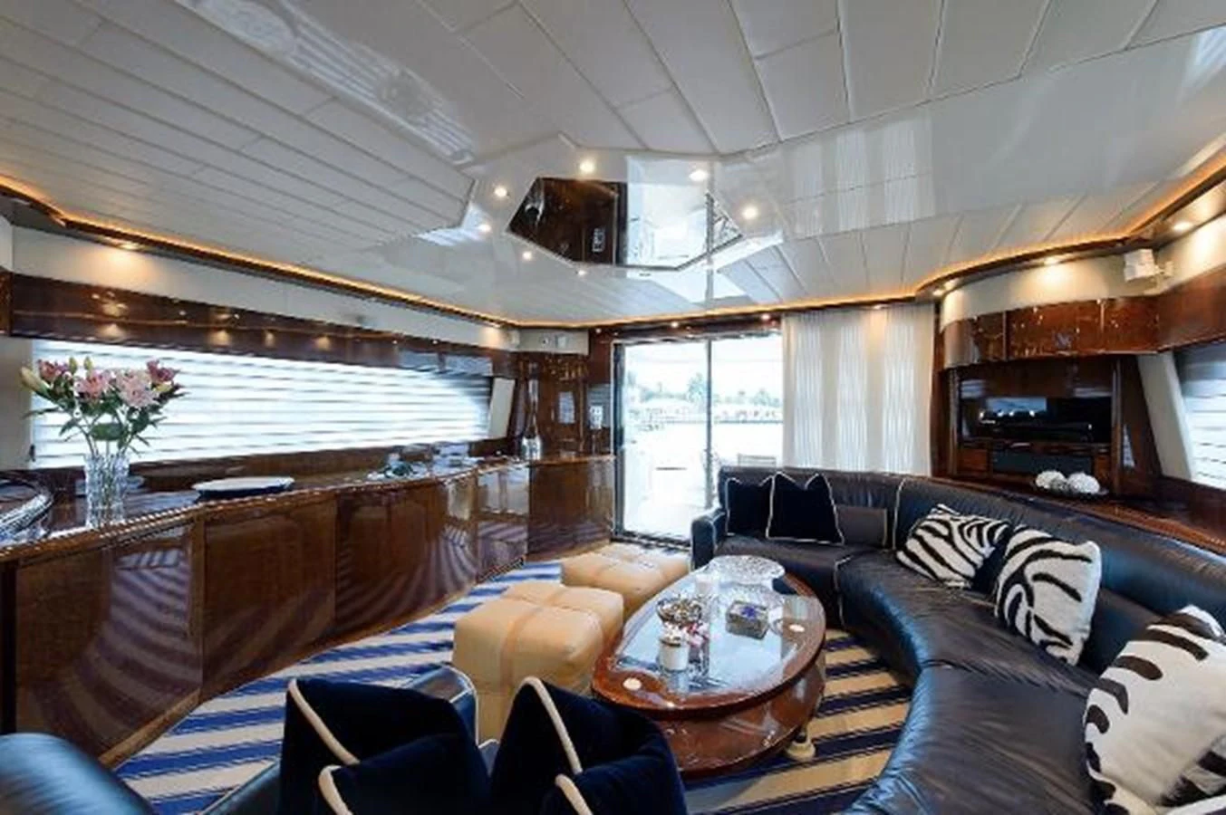 a living room with a large wood table and couches aboard UTOPIA Yacht for Sale
