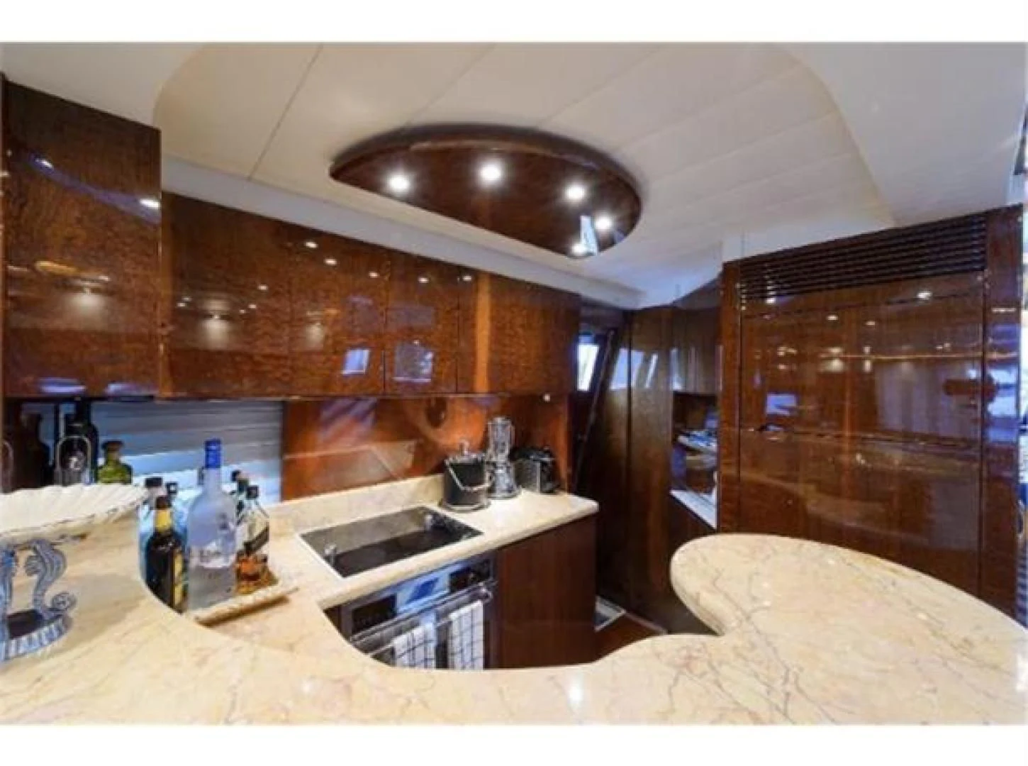 a kitchen with a sink and a bed aboard UTOPIA Yacht for Sale