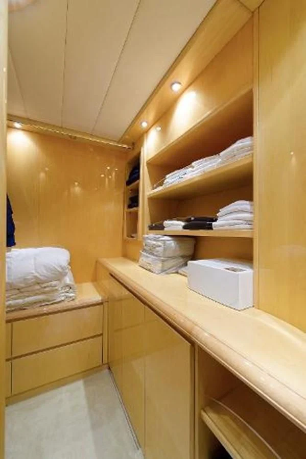 a room with a white counter and a white shelf with towels on it aboard UTOPIA Yacht for Sale