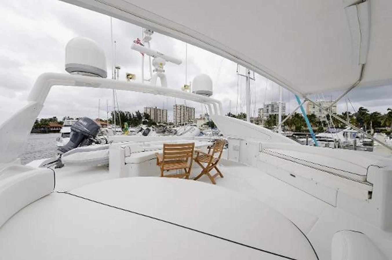 a white building with a white roof and chairs and a satellite dish on the roof aboard UTOPIA Yacht for Sale