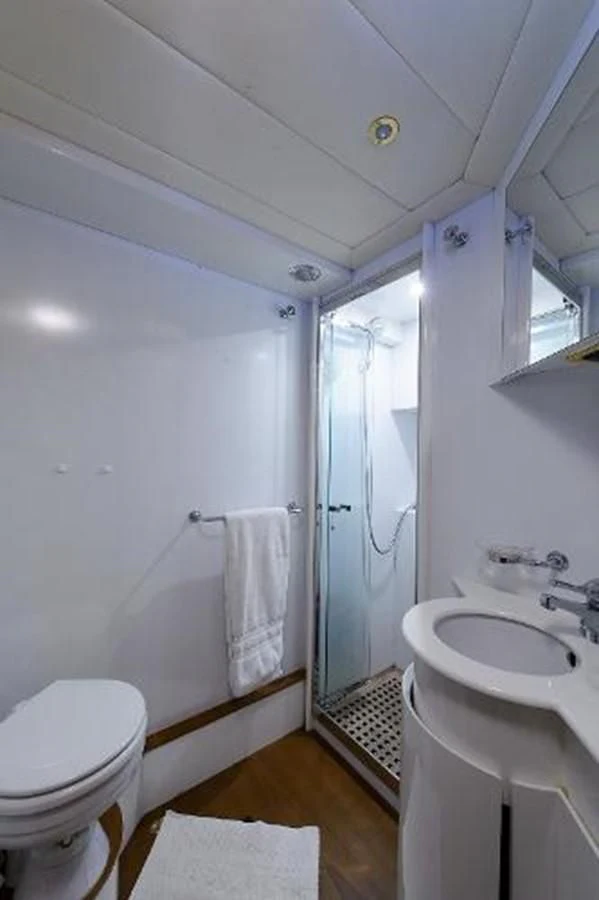 a bathroom with a shower sink and toilet aboard UTOPIA Yacht for Sale