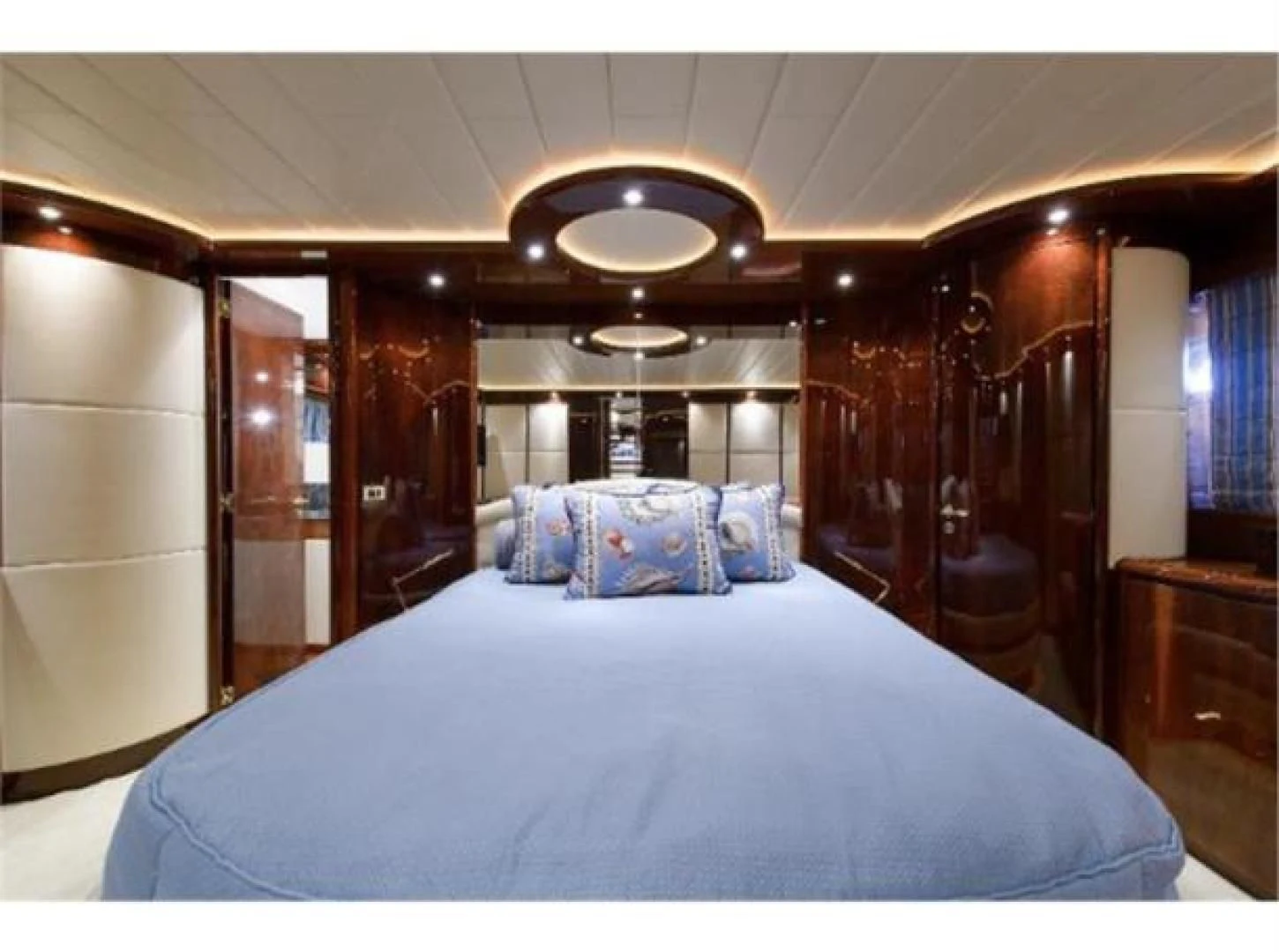a bed with blue sheets aboard UTOPIA Yacht for Sale