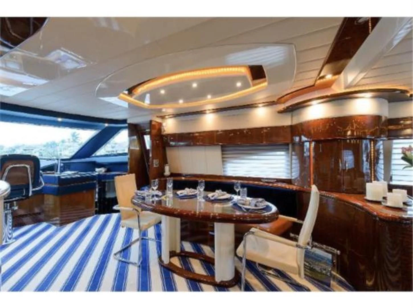 a boat with a table and chairs aboard UTOPIA Yacht for Sale