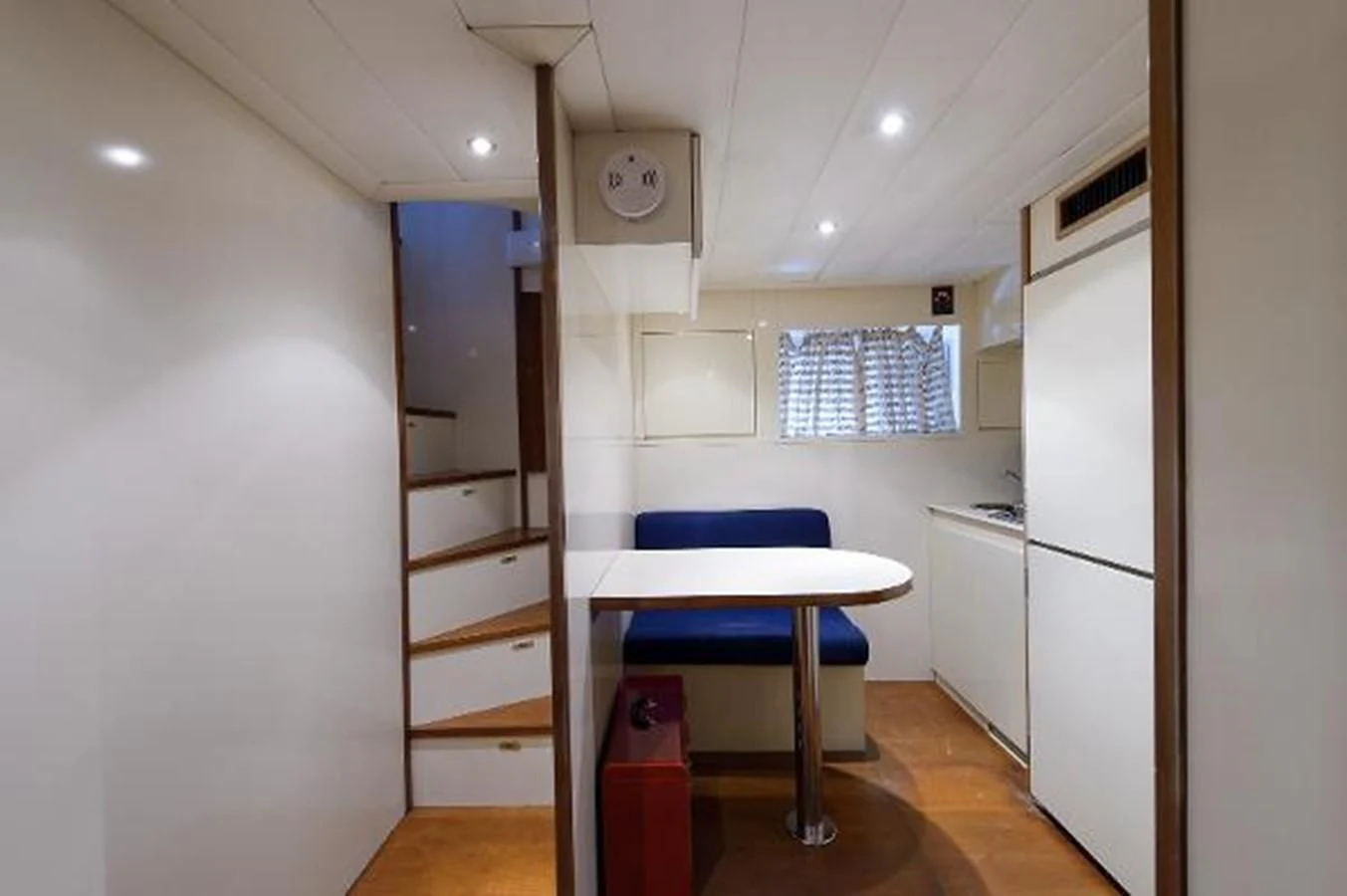 a kitchen with a blue chair aboard UTOPIA Yacht for Sale