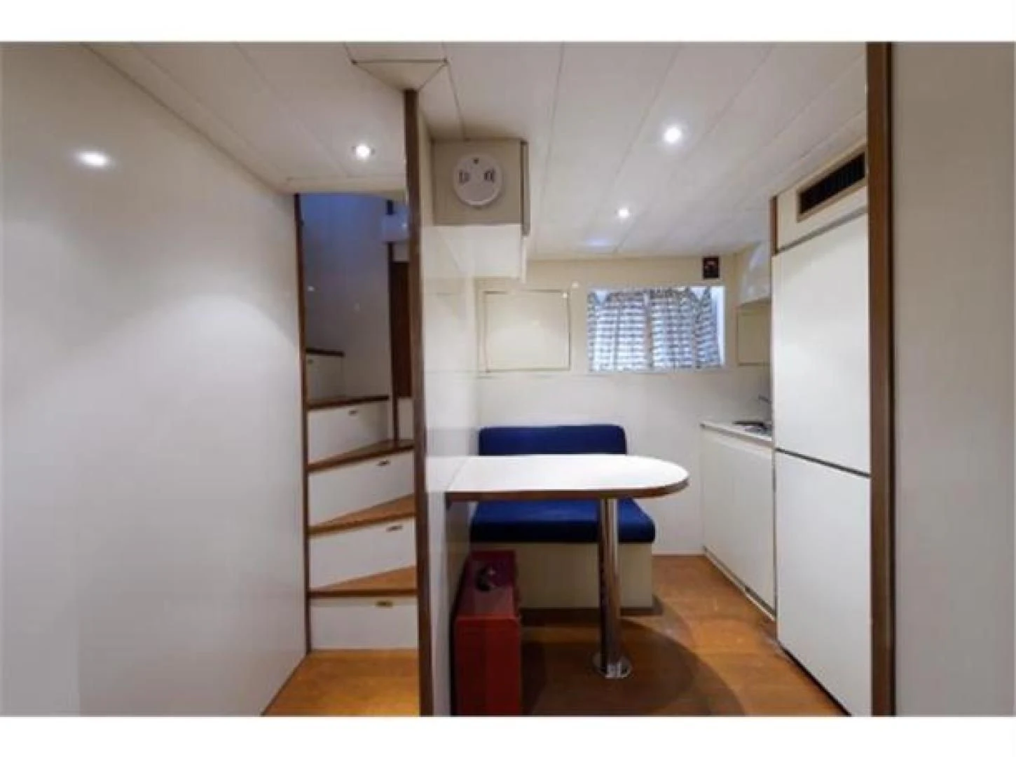 a kitchen with a blue chair aboard UTOPIA Yacht for Sale