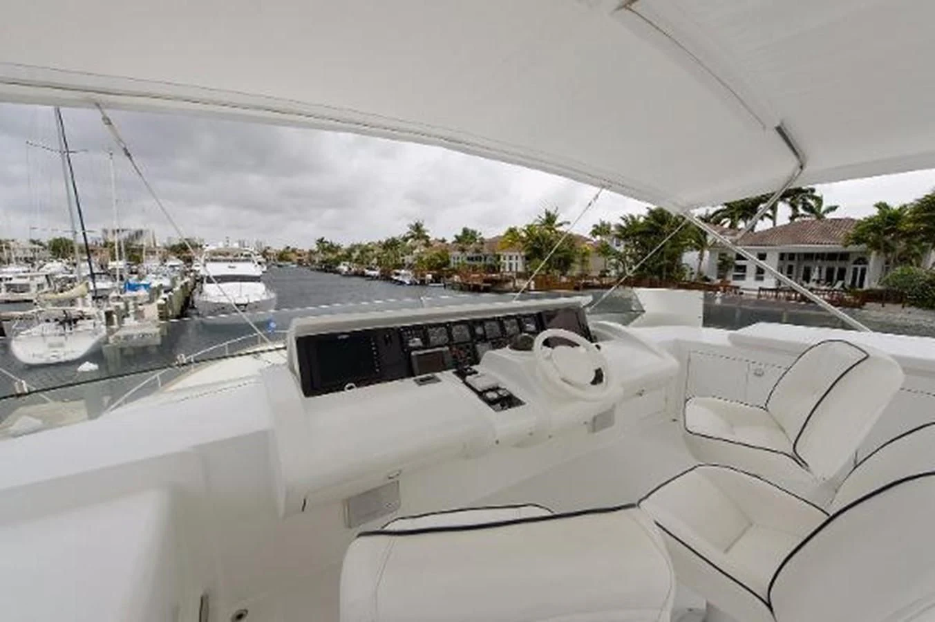 a white yacht in a harbor aboard UTOPIA Yacht for Sale